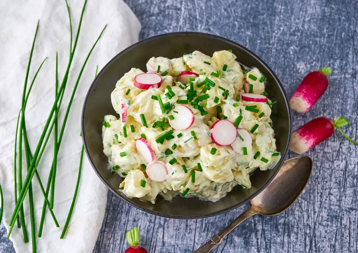 bowl with danish cold potato salad with chives and radishes