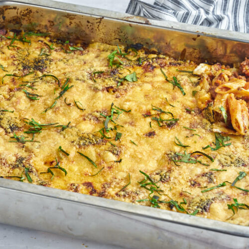 Italian lasagnette in ovenproof dish with wooden spoon