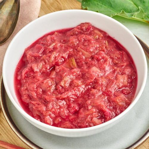 danish rhubarb compute in bowl with fresh rhubarbs