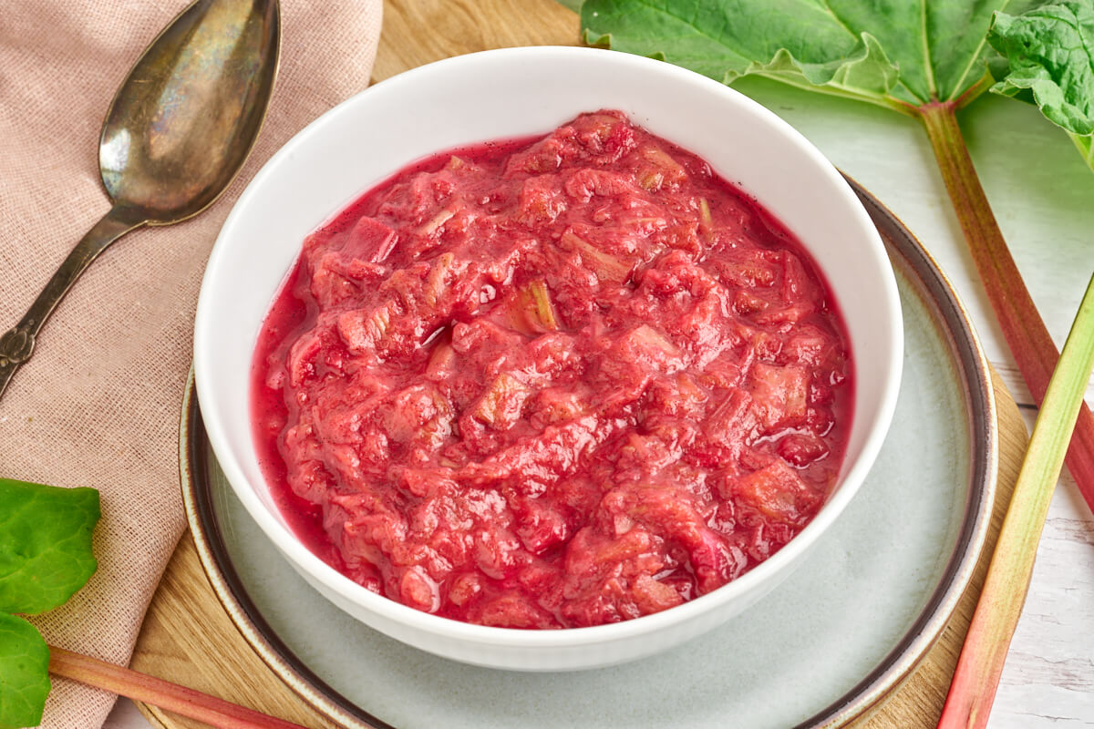 danish rhubarb compute in bowl with fresh rhubarbs