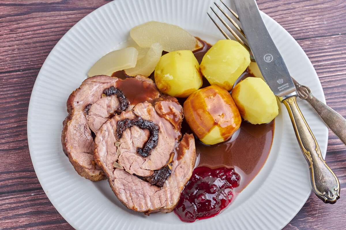 plate with danish rolled pork roast, potatoes and gravy