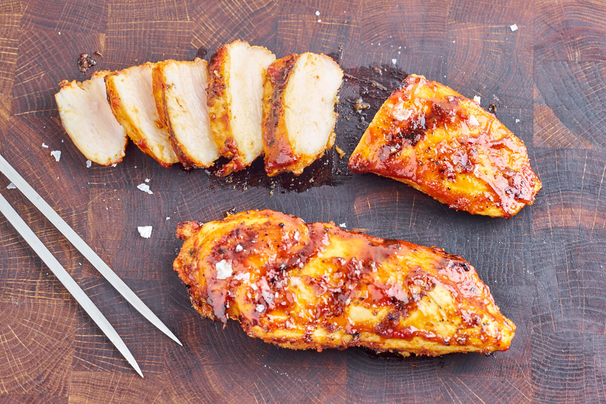 two grilled chicken breasts with barbecue marinade