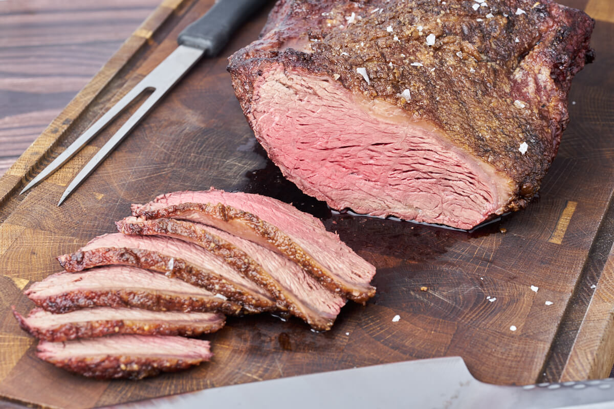 perfectly grilled picanha roast sliced on cutting board