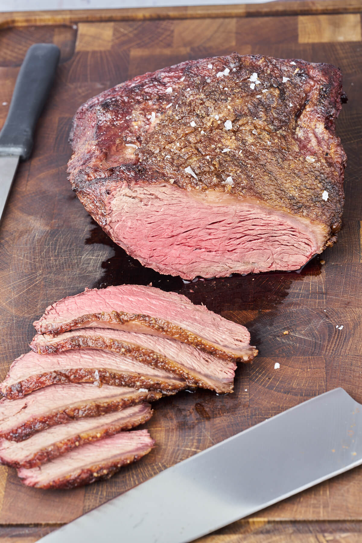 medium rump cap on grill sliced on wooden board