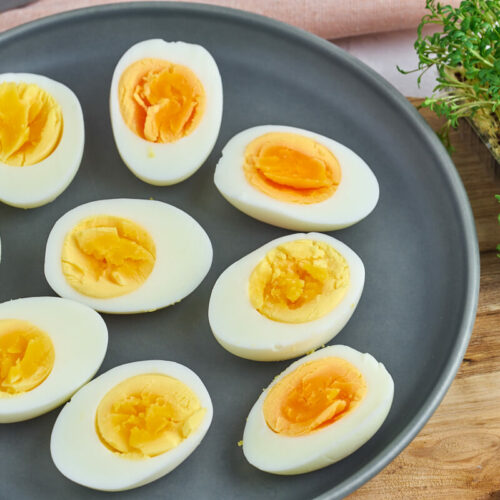 hard boiled eggs on plate with watercress