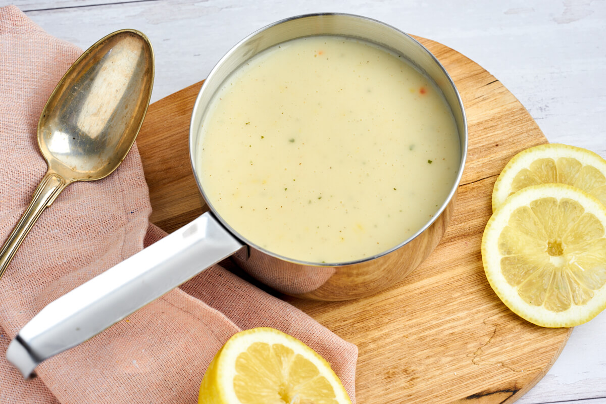 lemon sauce for fish or chicken in sauce pan with spoon end lemons