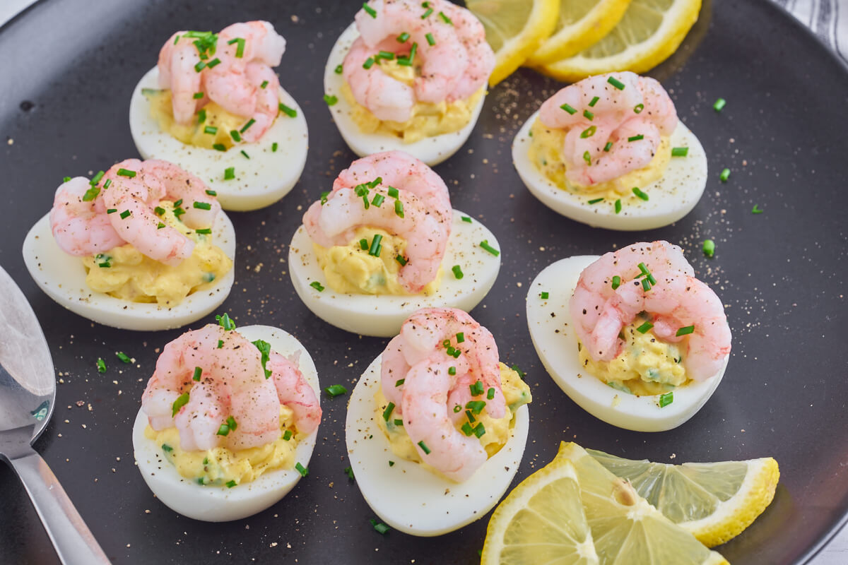 shrimp deviled eggs with lemon slices on plate