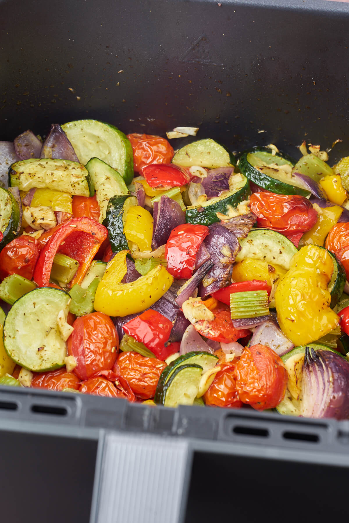 air fryer basket with mixed italian vegetables with oregano