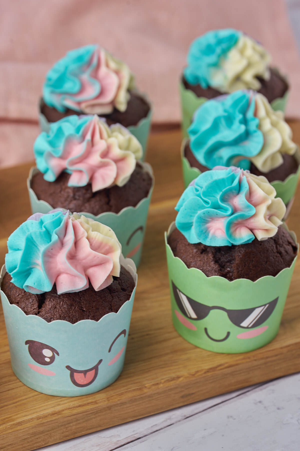 funny cupcakes with faces made of chocolate banana muffins with multicolored buttercream