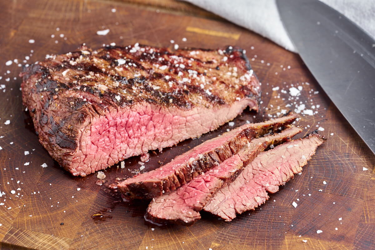 grilled beef flank steak with knife