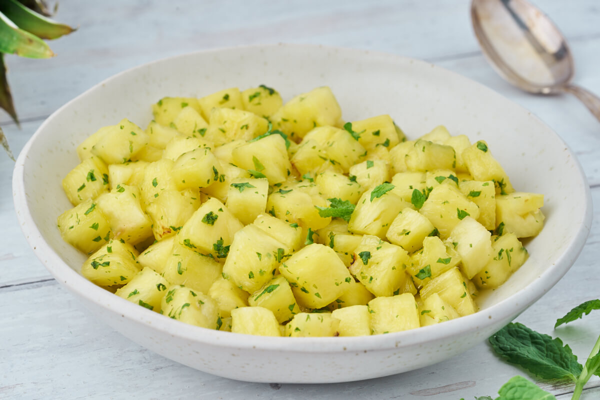 pineapple with mint sugar in bowl with spoon