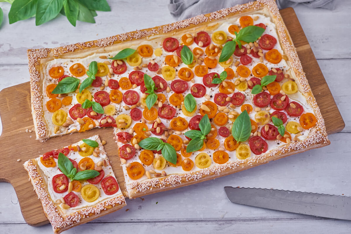 tomato tart on puff pastry with ricotta, pine nuts and basil