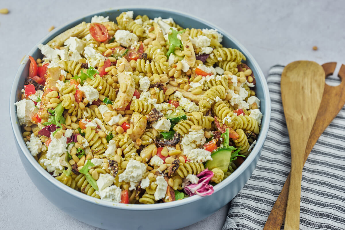 bowl with pesto pasta salad with chicken and feta