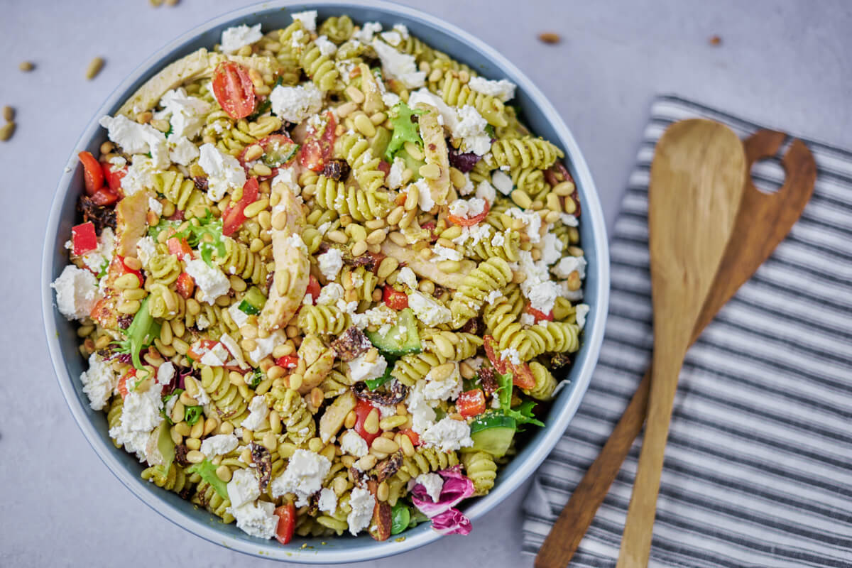 bowl with pesto chicken pasta salad and cutlery
