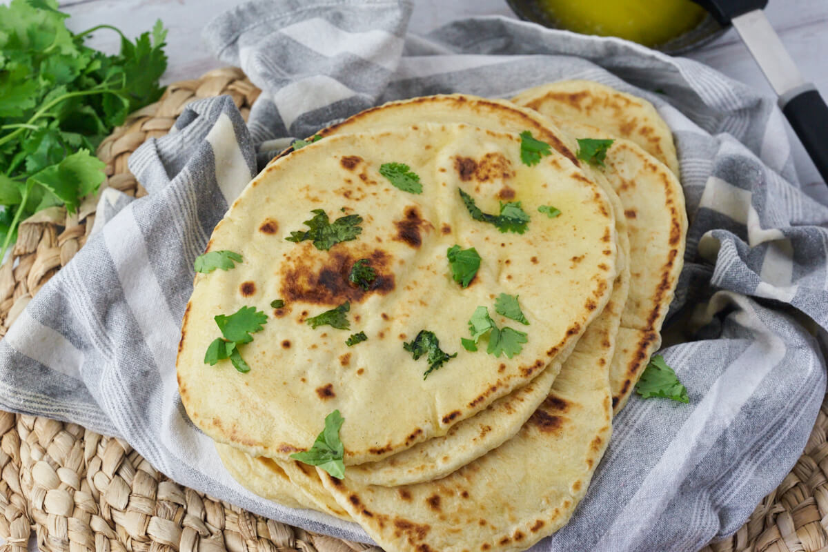 Indian naan bread is brushed with butter and coriander