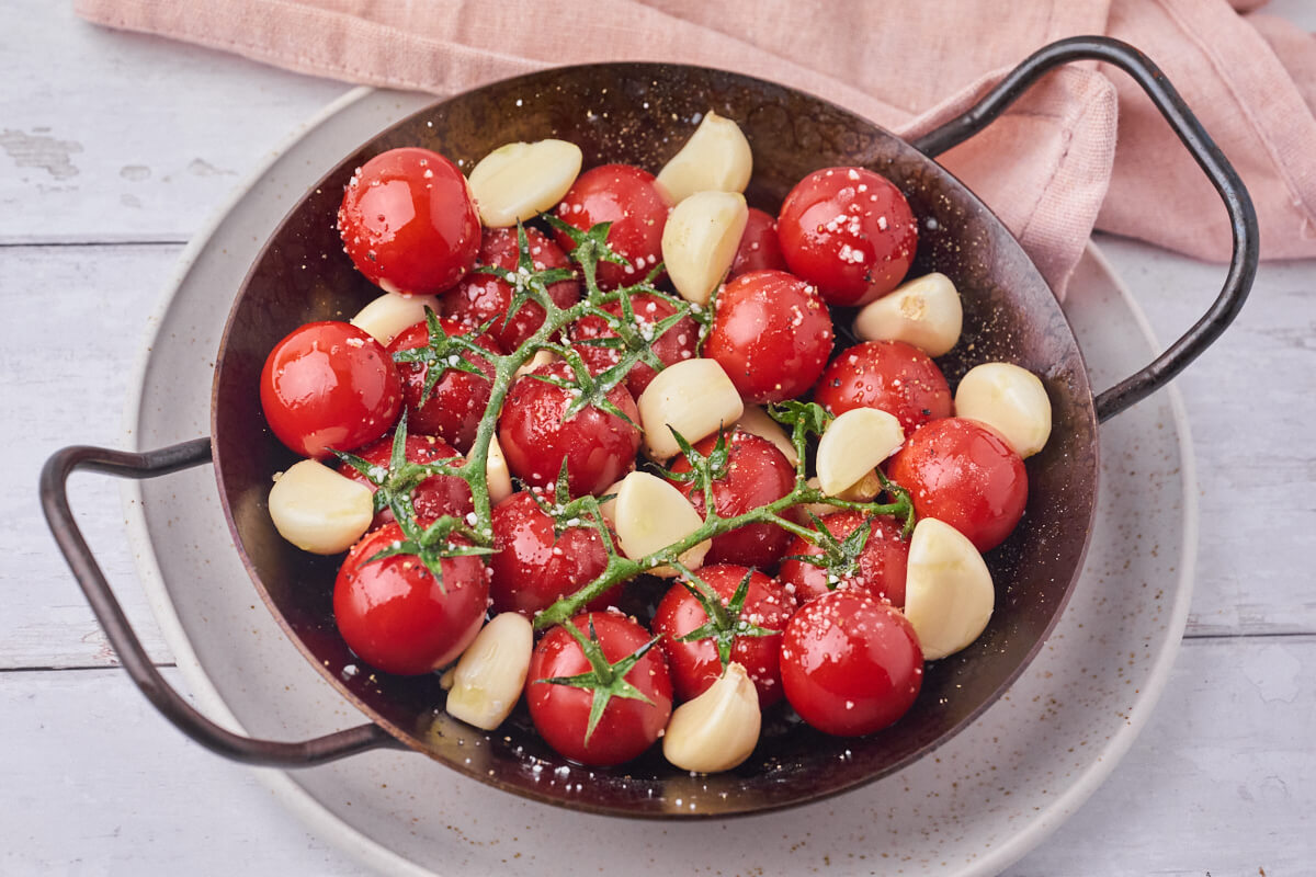 iron cast skillet with tomatoes with garlic