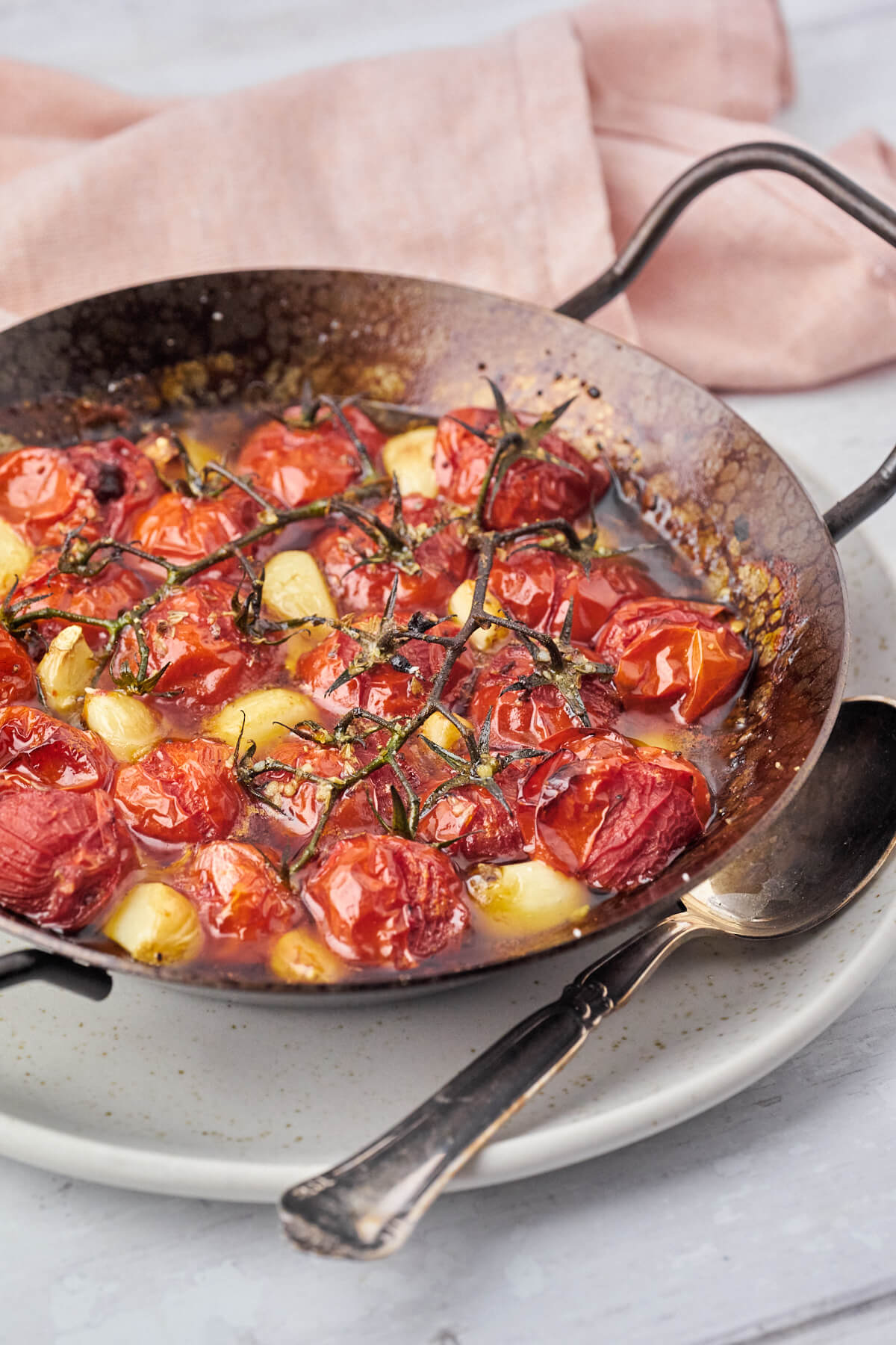 iron skillet with oven roasted tomatoes with garlic