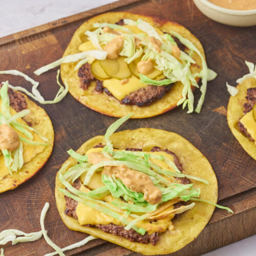 smash burger tacos on wooden chopping board