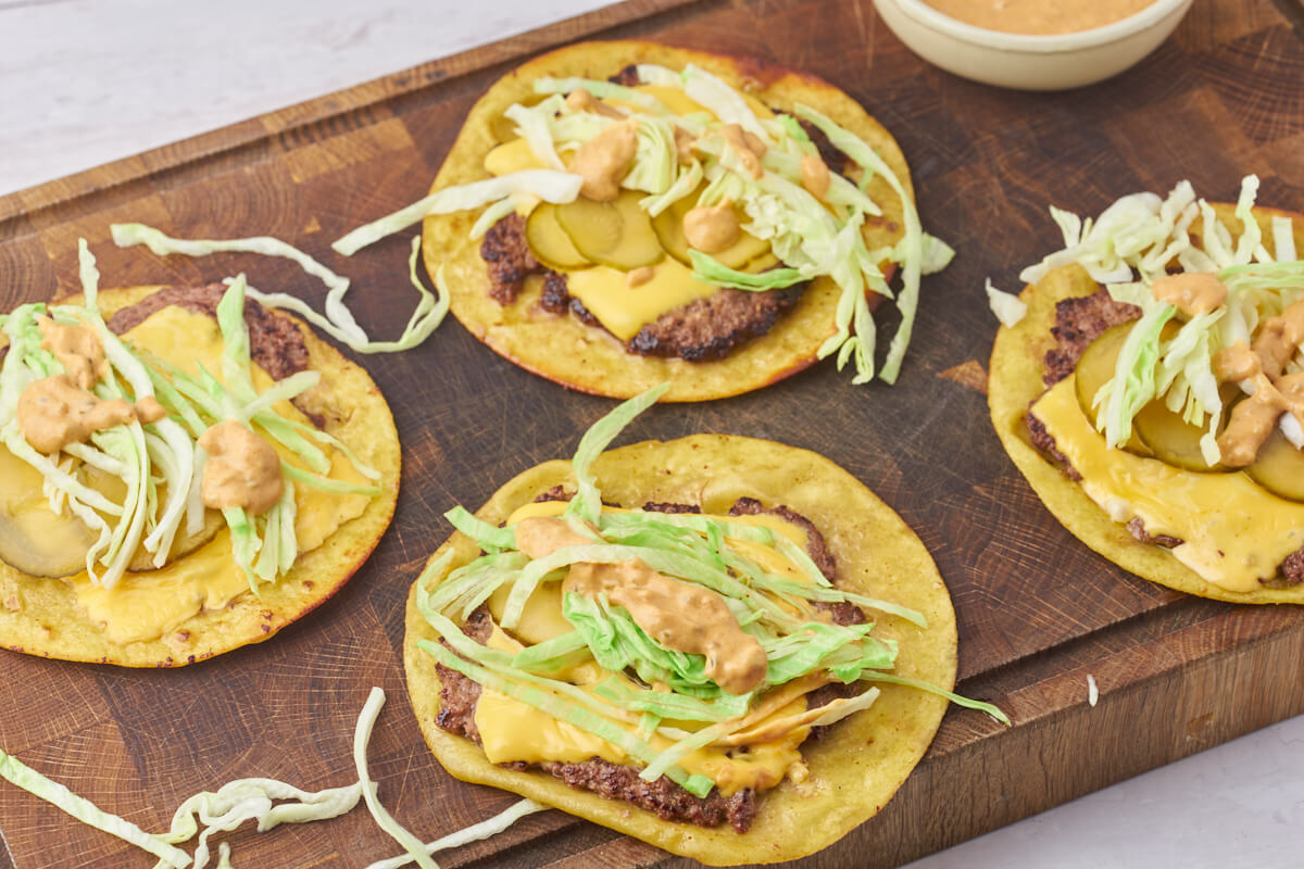 smash burger tacos on wooden chopping board