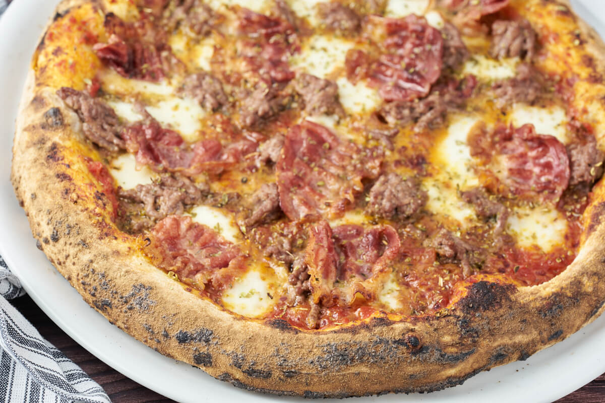 pizza with crispy crust and mozzarella, bacon and beef