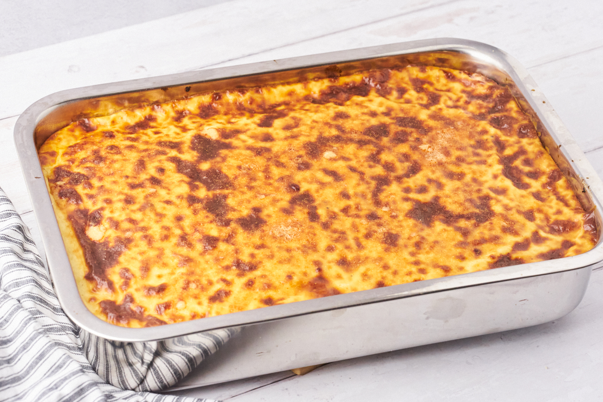 A large dish of Greek lasagna with macaroni, meat sauce, and a delicious béchamel on top