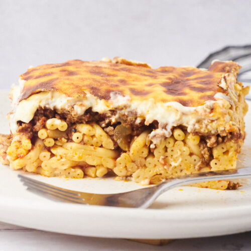 Pastitsio or Greek lasagna on a plate with a fork