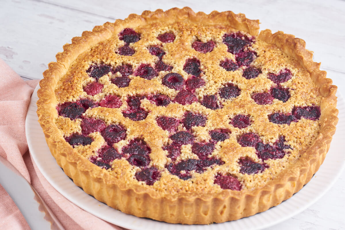 tart with raspberries and almonds on plate