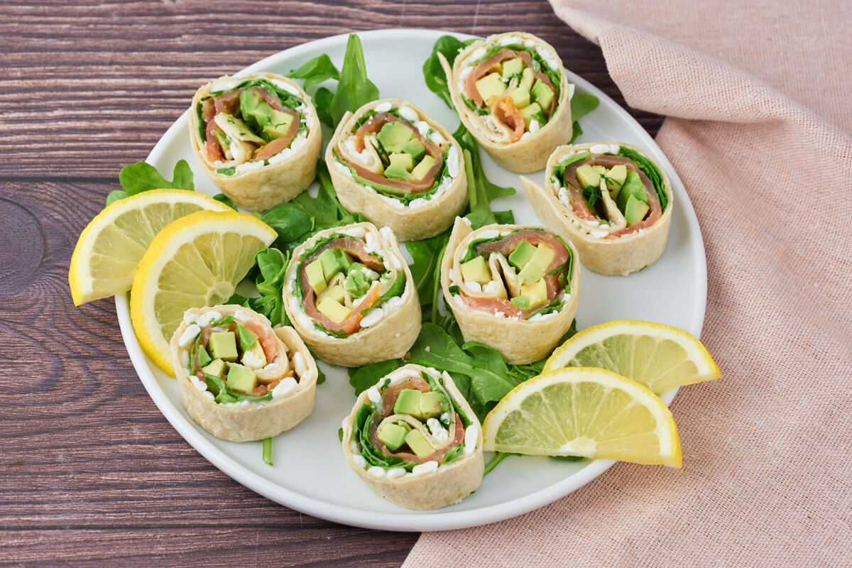 Salmon wraps with cottage cheese and avocado on a platter