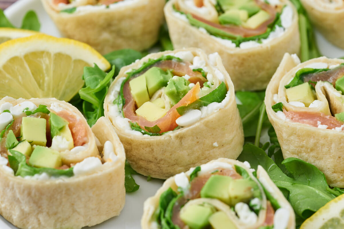 Delicious salmon rolls in tortilla wraps with avocado