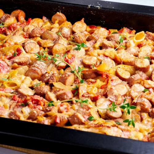 easy sausage pasta bake with bell peppers and fresh thyme on top