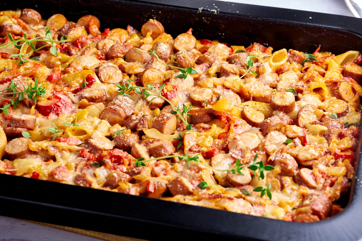 easy sausage pasta bake with bell peppers and fresh thyme on top