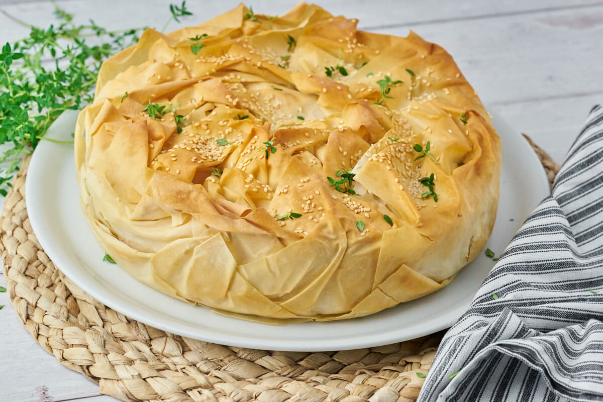 Spanakopita on a platter with thyme
