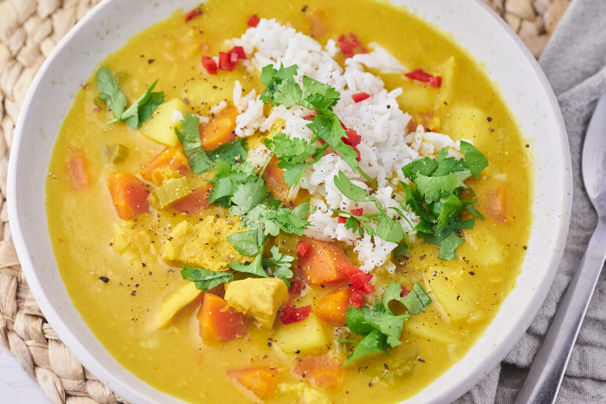 topping on the soup is rice, red chili finely chopped and fresh cilantro