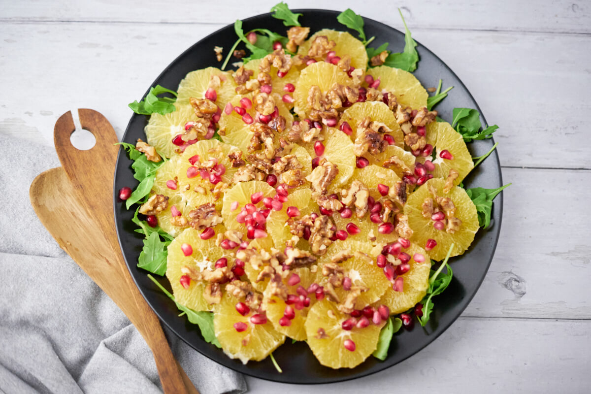 Delicious platter of orange salad with pomegranate and walnuts.